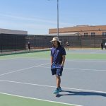 Tennis Coach Has Reserved Demeanor, Yet Powerful Impact